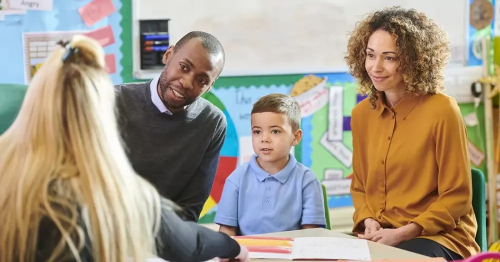 Teachers working one-to-one with a young student