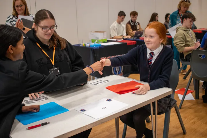 Debaters shaking hands across the table