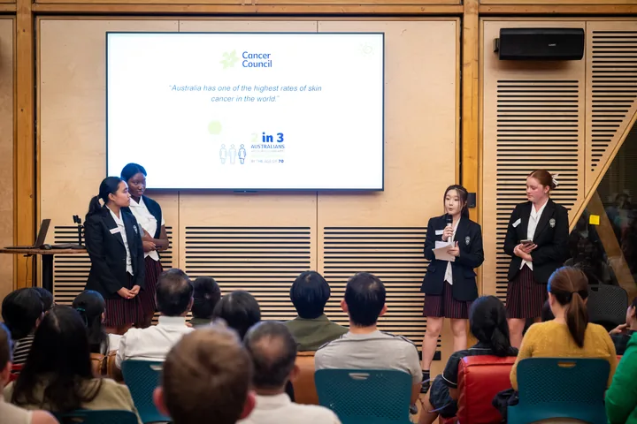Students presenting on stage